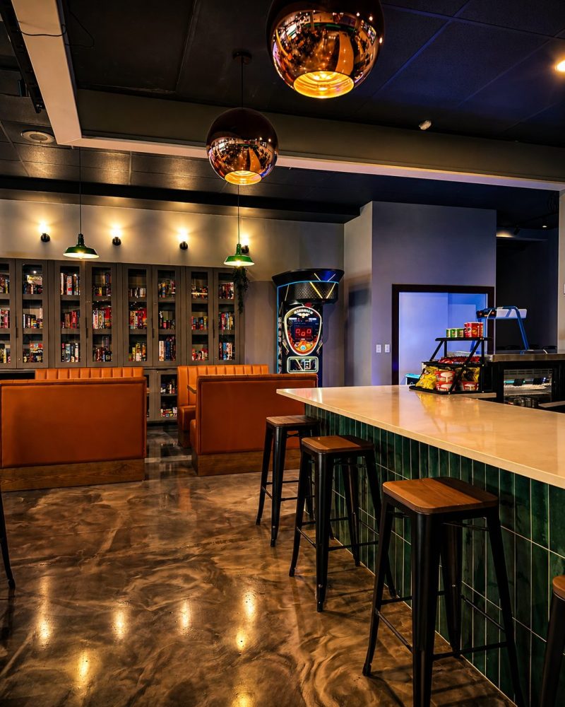 Bar counter, leather booths and game shelving at Cue's N Cushion
