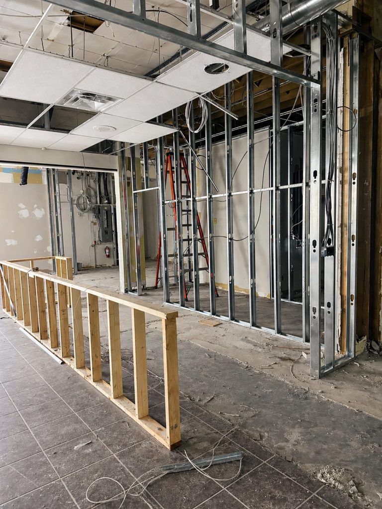 Steel stud framing during construction at Cue's N Cushion